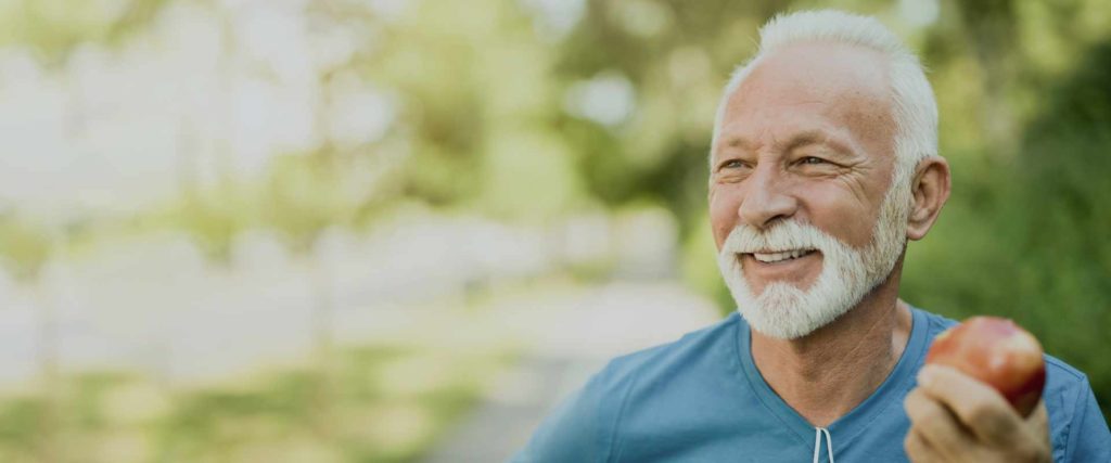 Man smiling with apple